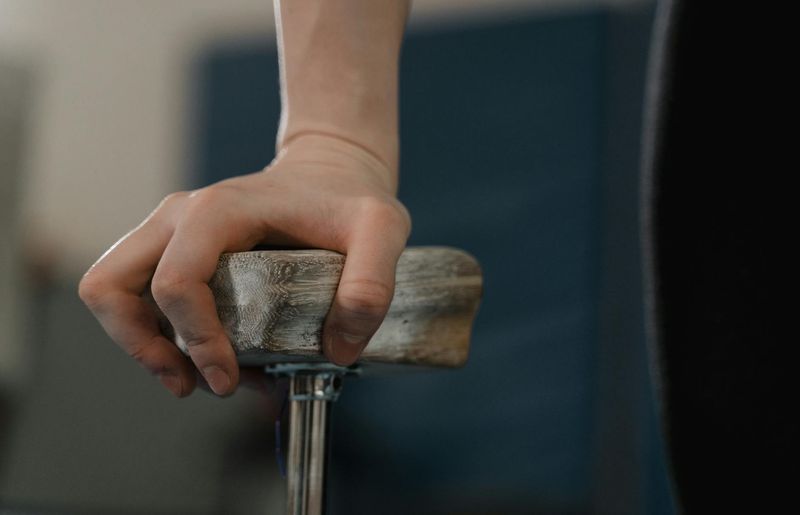 Close-up shot of an athlete's hands gripping the floor with intense focus.