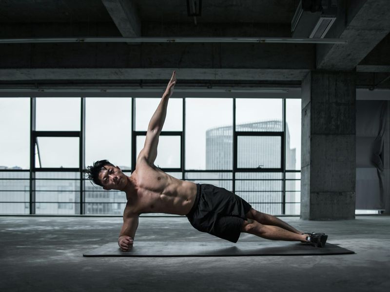 Man in a state of deep focus during a difficult bodyweight exercise.